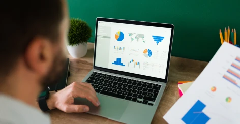 A man reviewing an analytics dashboard on a laptop