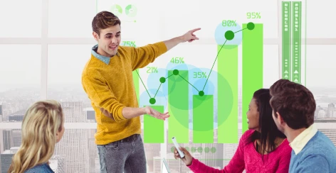 Presenter pointing at a rising bar chart for colleagues