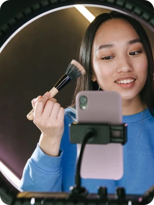 Creator filming a makeup tutorial on a phone