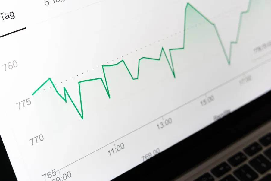 A rising line graph on a laptop screen